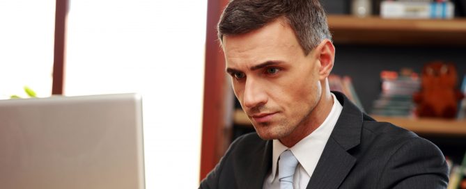 Confident courtroom presentation tech sitting with laptop at office